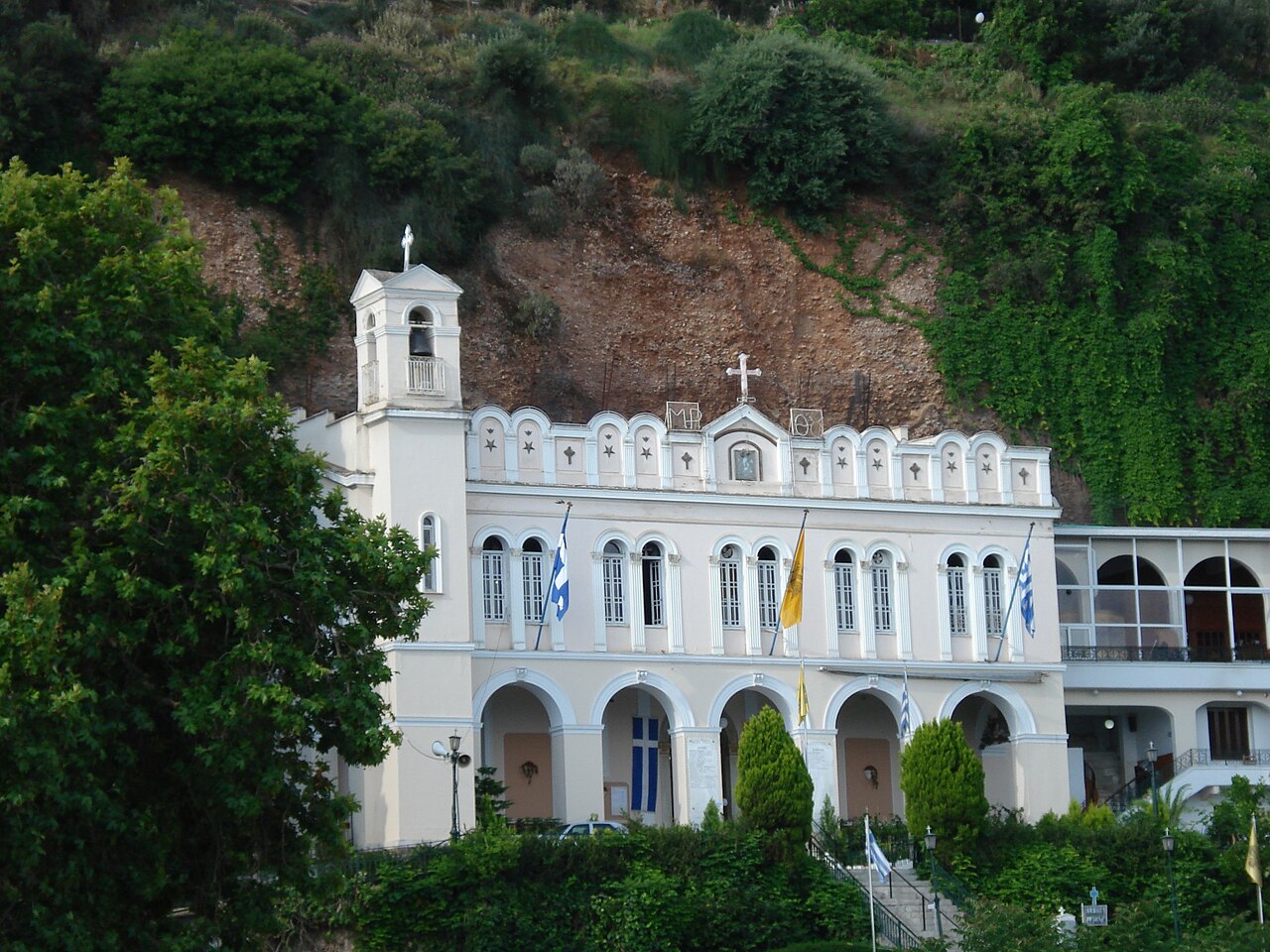 Aegion - Church of Panagia Tripiti

Panagia Tripiti (Greek: Παναγία Τρυπητή) is an historical sacred shrine of Theotokos in the town of Aigio, Greece.It is one of the most important orthodox shrines of pilgrimage in Greece. The shrine is dedicated to the Mother of God of the Life Giving Spring. It is built on a steep cliff almost 30 meters high, near to sea .The many and impressive miracles which occur through the intercessions of the Virgin Mother have cansecrated the church in the conscience of the faithful as a national shrine. Thousand of believers, from all over Greece, arrive at Aigio on bright Friday every year, to get Panagia's grace and to get Her blessing. This day every year there is a procession of the Holy Icon through the streets of Aigio and it is an official religious holiday. The name Tripiti comes from the greek word tripa (Greek: Τρύπα) meaning hole,cave, because the miraculous icon of Panagia was found in a hole in the rock. In the narthex of the church (which is on the ground floor) there is a spring of water (Greek: Αγίασμα).The faithful drink this water as a blessing since it is believed that it works miraculous cures.