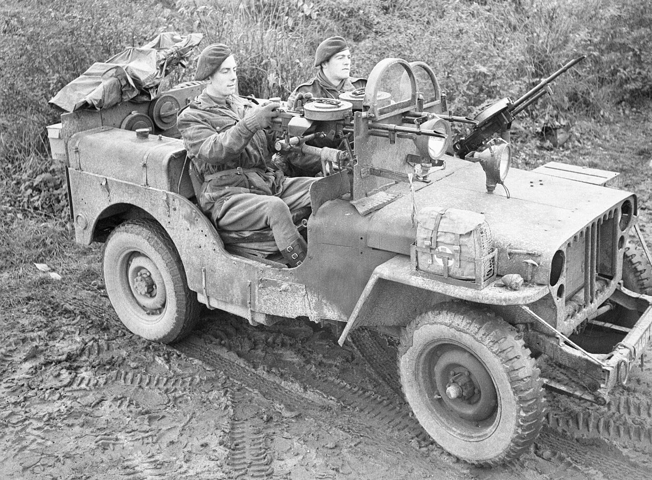 An SAS jeep manned by Sergeant Schofield and Trooper Jeavons of 1st SAS near Geilenkirchen, Germany, 18 November 1944.
A jeep manned by Sergeant A Schofield and Trooper O Jeavons of 1 SAS near Geilenkirchen in Germany. The jeep is armed with three Vickers 'K' guns, and fitted with armoured glass shields in place of a windscreen. The SAS were involved at this time in clearing snipers in the 43rd Wessex Division area.