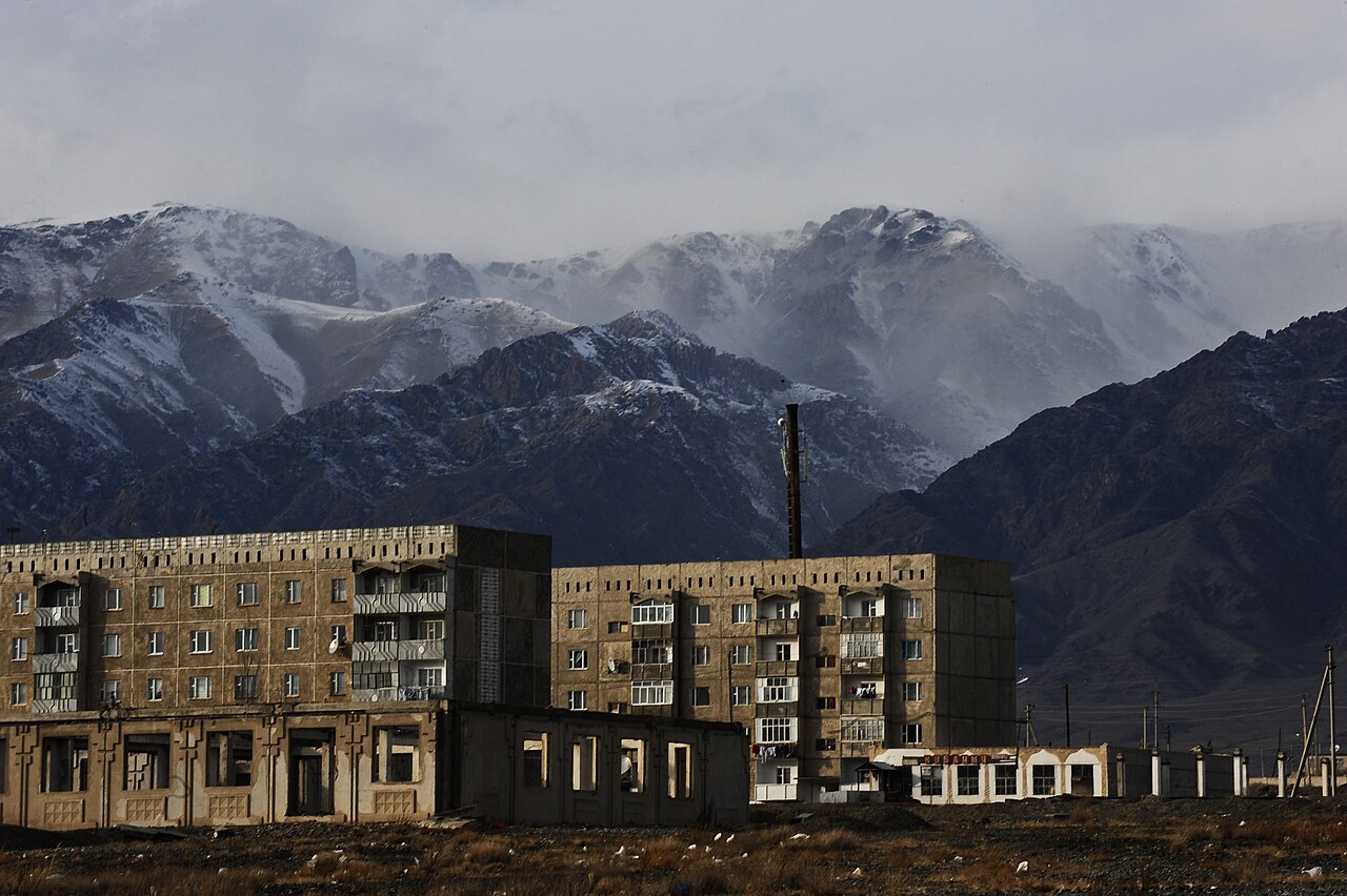Apartment buildings stand close to mountains near a school in Balykchy, Kyrgyzstan, January 15, 2012.