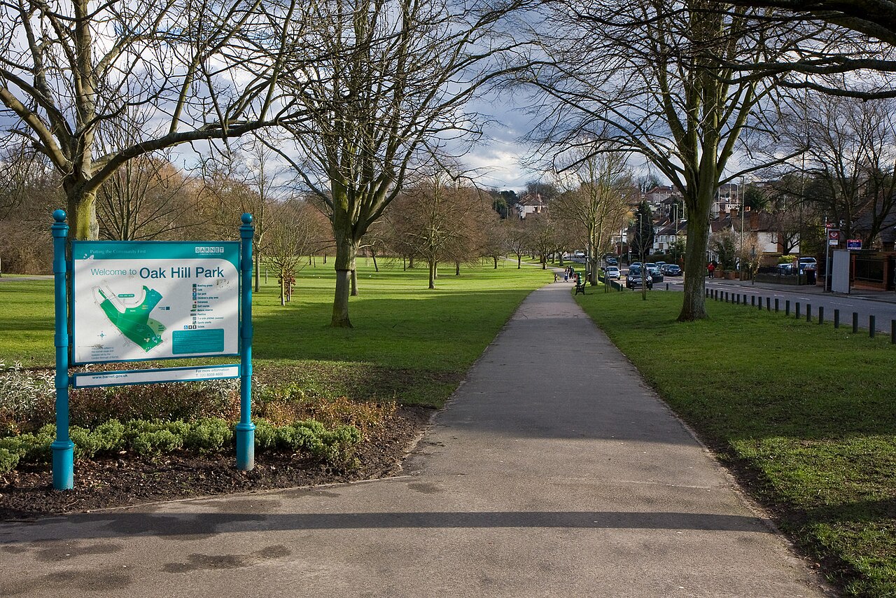 Oak Hill Park Looking along a footpath that runs parallel with Church Hill Road.  The map board on the left displays the locations of a number of amenities within the park.