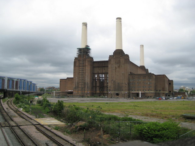 Battersea Power Station viewed from the south.  On the left is the final merger of Southern's lines for Southern's main terminus (Victoria Station) which is the next station along the line to the north.  Far left: Warwick and Howard Buildings, Chelsea Bridge Wharf (apartments).