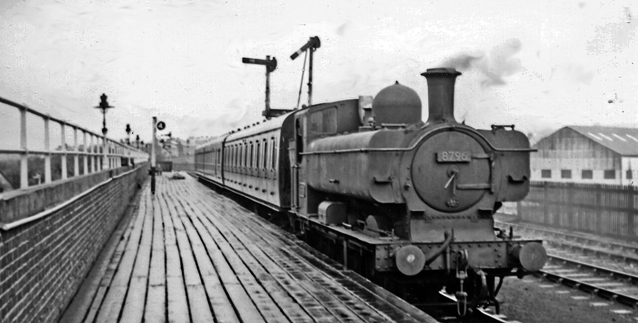 Brynmawr station, with local train from Newport.
View westward, towards Merthyr on the ex-LNW Abergavenny - Merthyr line (closed 1/58), from which branched left (southward) the line to Newport (ex-GW &amp; LNW Joint as far as Nantyglo, then GWR). Brynmawr station was closed on 30/4/62 when the Newport service ceased. See also SO1911 : Site of Brynmawr Station. The locomotive is '8750' class 0-6-0PT No. 8796 (built 3/34, withdrawn 4/61).
