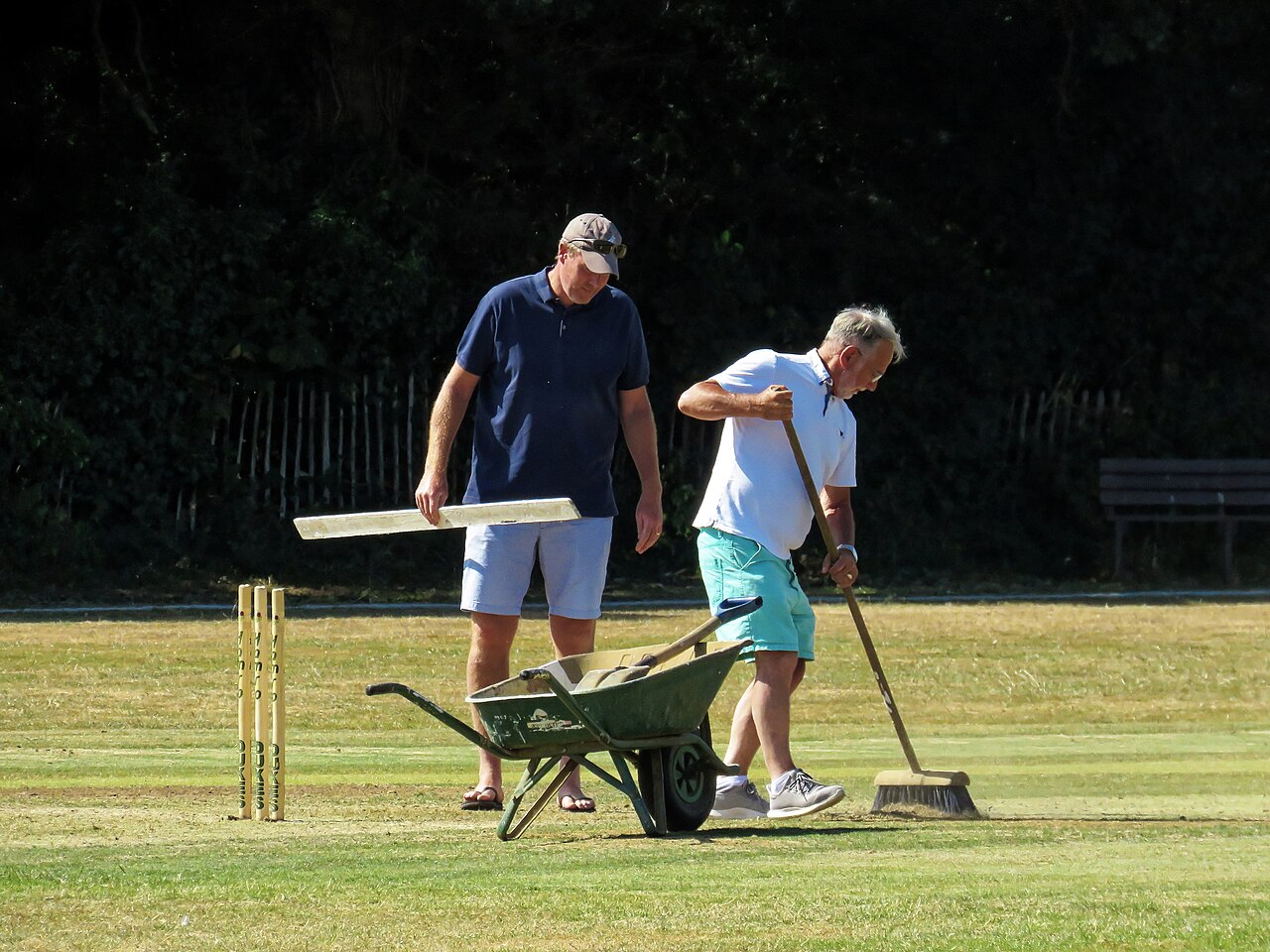 Preparing the pitch for the second innings during a timed Essex League game on Saturday 6 August 2022 between Buckhurst Hill Cricket Club Saturday 1st XI (batting), and Upminster Cricket Club Men's 1st XI. Result: Buckhurst Hill 251 all out in 49.3 overs; Upminster 120 all out in 30.1 overs.Mobile device view: Wikimedia (2022) makes it difficult to view photos related to this image, so to see its most relevant allied group, click: Buckhurst Hill Cricket Club, Upminster Cricket Club, Minor cricket clubs of Essex, and this uploader's Cricket photos. You can add a click-through 'categories' button to the very bottom of photo-pages you view by going to settings... three-bar icon top left.Desktop view: Wikimedia (2022) makes it difficult to immediately view the helpful category links where you can find images related to this one in a variety of ways; for these go to the very bottom of the page.This image is one of a series of date and/or subject allied consecutive photographs kept in progression or location by file name number and/or time marking.Camera: Canon PowerShot SX60 HSSoftware: File lens-corrected, optimized, perhaps cropped, with DxO PhotoLab 4 Elite, and likely further optimized with Adobe Photoshop CS2.