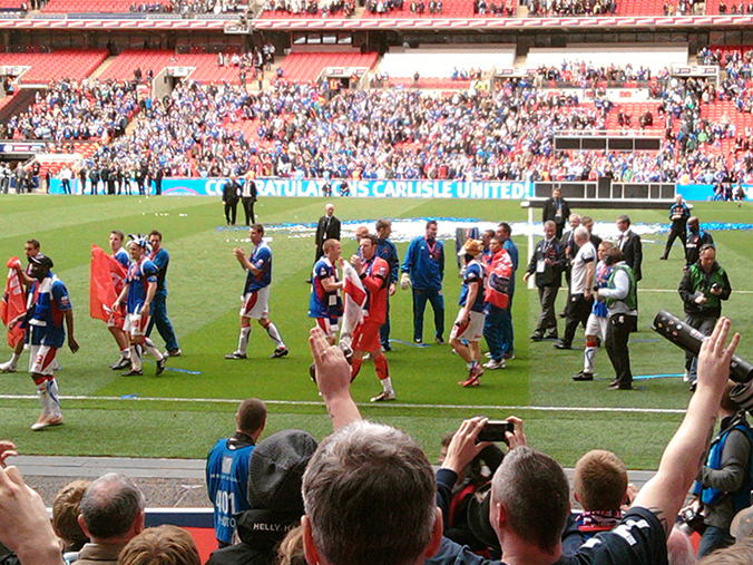 The Carlisle United team thank their fans after winning the 2011 FA League Trophy at Wembley Stadium.