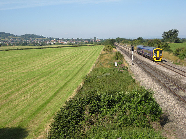 Travelling from Gloucester to Cheltenham The train is about to pass under the bridge north of Reddings Farm. Lower slopes of Tinker's Hill can just be seen on the left behind the houses in Churchdown.