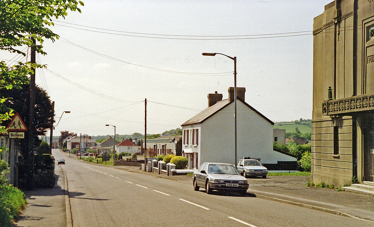 Site of Cross Hands station, 1990.
View SE on the A48, the station had been on the right: terminus of the ex-GW Llanelly &amp; Mynydd Mawr line. Passenger services for colliery workers lasted until 1928, but freight up the Gwendraeth Valley continued until the colliery at Cynheidre closed in 1983.