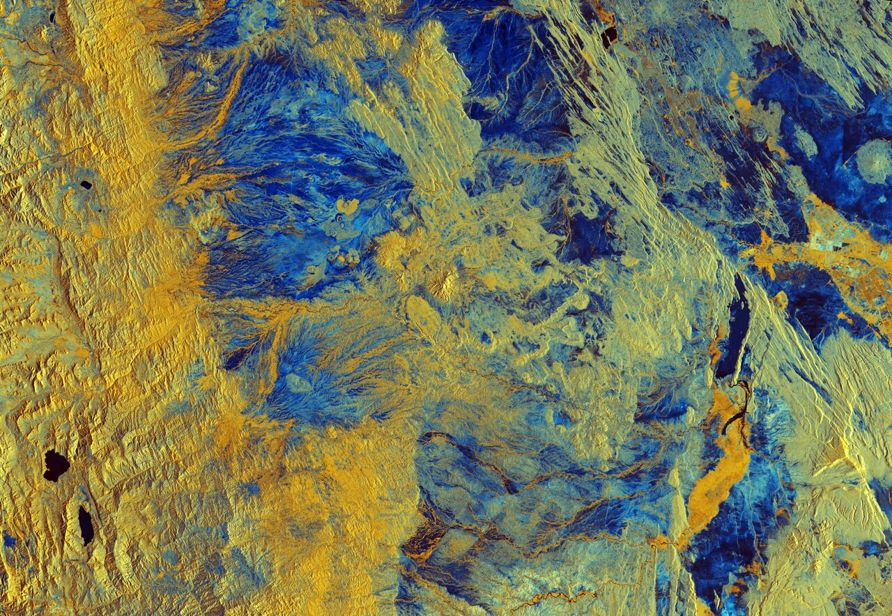The Copernicus Sentinel-1B satellite takes us over Semera in northeast Ethiopia. Semera is a new town with a population of just over 2600 and serves as the capital of the Afar region. The region spans an estimated 270 000 sq km, from close to the border with Eritrea towards the capital of Addis Ababa.We can see the regional capital in the top right of this false-colour image, with the larger urban centre of Dubti just south of the town. Both are found in the Great Rift Valley, which lies between the Ethiopian Plateau and the Somalia Plateau.The landscape of the Afar region is characterised by desert shrubland and volcanoes, particularly in the north. In this image we can see differences in altitude represented in the variations in colour. The left part of the image is dominated by yellow, signifying changes in vegetation found at higher altitudes. Two lakes, Hayk Lake and Hardibo Lake, are shown in the bottom left.South of Dubti we can see the Awash River, which flows into the northern salt lakes rather than into the sea. Salt trade is typical of the area, whilst cotton is grown in the Awash River valley. Maize, beans, papaya and bananas are also cultivated in the Afar region. It is thought that 90% of the region’s population lead a pastoral life, rearing animals such as camels, sheep and donkeys.Dallol, to the north of Semera in Ethiopia’s Danakil Depression, is frequently cited as one of the hottest inhabited places on Earth. Lying 125 m below sea level, with temperatures in the spectacular hydrothermal fields averaging 34.4 °C year-round, and the area receiving just 100–200 mm rainfall a year, conditions are thought to be amongst the most inhospitable in the world.Sentinel-1B was launched in April 2016, carrying an advanced radar instrument to provide an all-weather, day-and-night supply of imagery of Earth’s surface. Along with Sentinel-1A, which was launched in April 2014, the mission benefits numerous services, including monitoring land-surface for motion risks and mapping to support crisis situations.This image, which was captured on 5 April 2018, is also featured on the Earth from Space video programme.