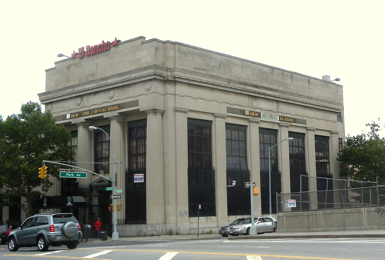 Looking northwest across Park and Tremont Avenues in East Tremont, at former bank building on a cloudy morning.