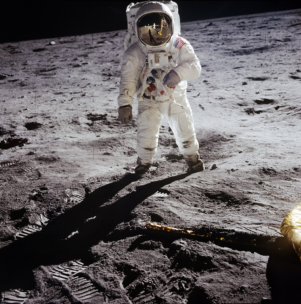 Apollo 11 Hasselblad image from film magazine 40/S - EVA. The image of astronaut Neil Armstrong photographing astronaut Aldrin is clearly seen in the reflections on the helmet visor of astronaut Aldrin. Astronaut Armstrong, the Lunar Module Eagle, and the shadow cast by Aldrin are mirrored in the reflection. Astronaut Aldrin showing boots and suit discoloration caused by adhering lunar soil.