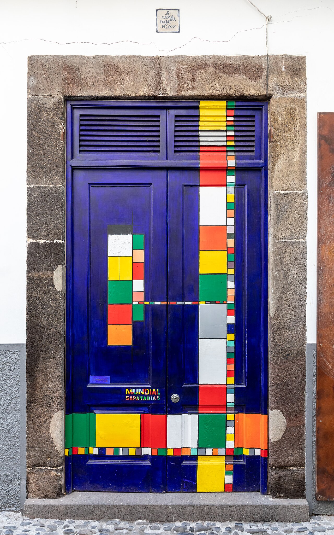 Artistically designed front door “Rua de Santa Maria 39” (The arT of oPEn doORs), Funchal, Madeira, PortugalThe project “artE das pORtas Abertas” in Rua de Santa Maria and its side streets in Funchal is an art project by various artists that aims to open doors to art and culture. These art interventions take into account all visual arts, from painting and photography to writing.The project was initiated by artist José Maria Montero Zyberchema and former Regional Secretary for Tourism and Culture João Carlos Abreu. The first door to undergo an intervention was number 207 on Rua de Carreira in Funchal by Martinho Mendes on August 20, 2010. The first door in Rua Santa Maria was painted on April 6, 2011, by artist Mark Milewski at number 77, which took him more than a month to complete. However, the first artistic intervention was started and completed by Gonçalo Martins in Rua Santa Maria nos. 81 to 83 on April 9, 2011.