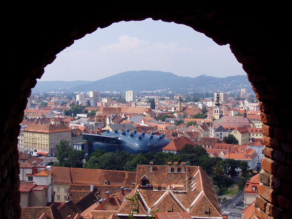 Aerial view of Graz, Austria with Kunsthaus Graz visible.