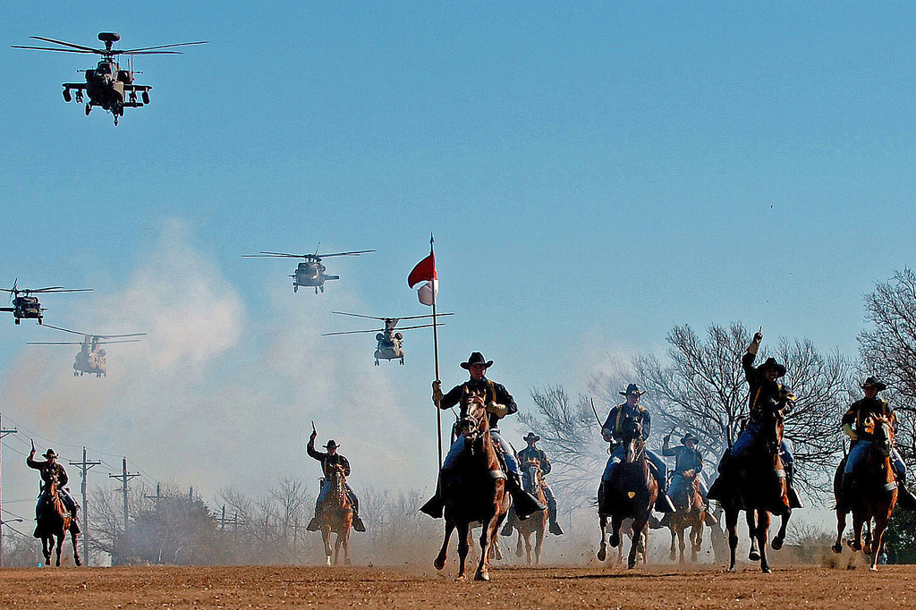 Following the casing of the brigade, battalion and division colors, soldiers assigned to the 1st Cavalry Division Horse Detachment perform a cavalry charge accompanied by a helicopter flyover performed by the 1st Cavalry Division Air Cavalry Brigade on Fort Hood's Cooper Field, Texas, Dec. 12, 2008. U.S. Army photo by Pfc. Phillip Turner