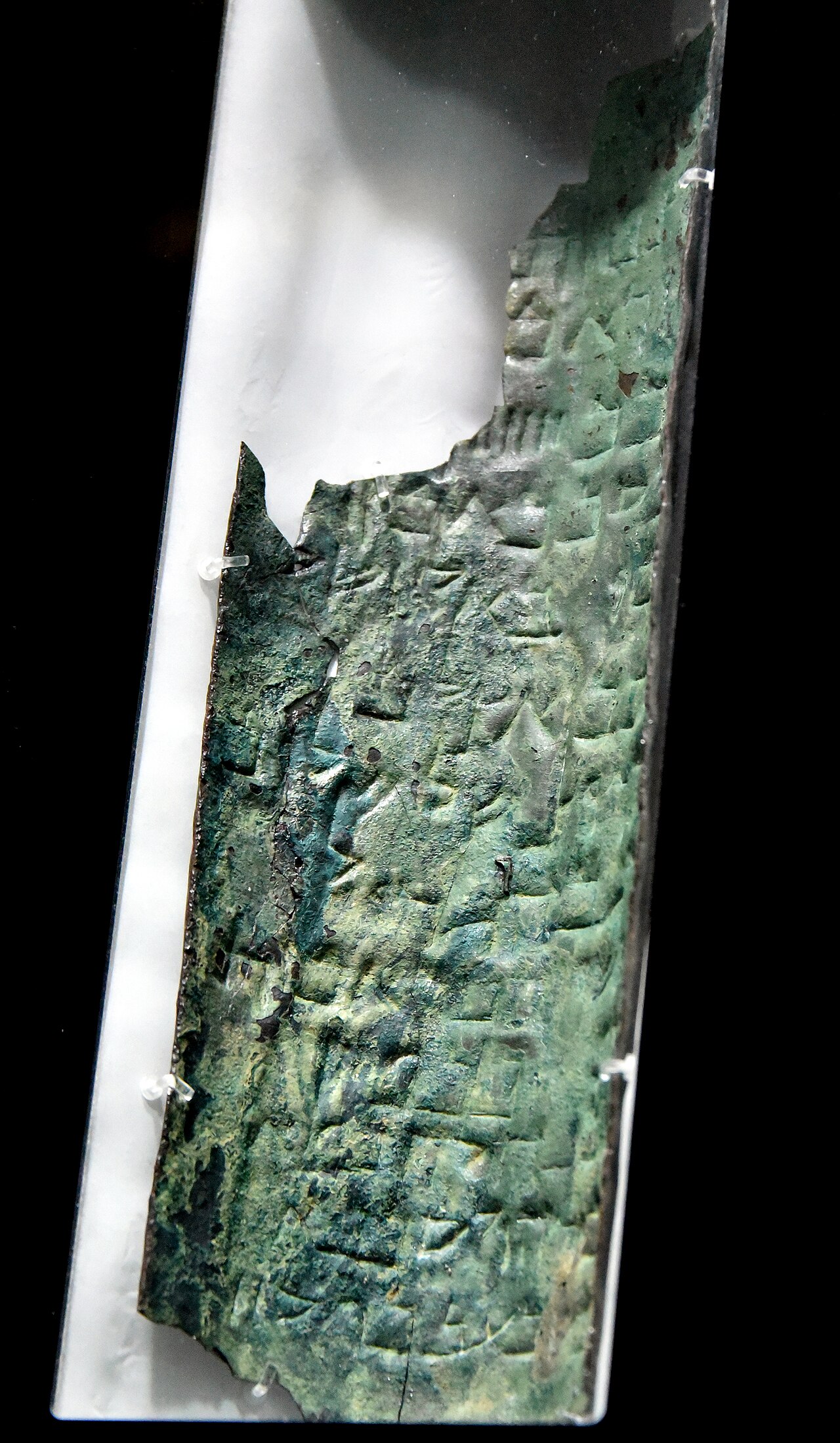 Strip 11, part of the Copper Dear Sea Scrolls. Discovered Cave Q3 at Qumran, this is the only known inscription on metal from the Dead Sea Scrolls. This scroll consisted of 3 sheets, totaling 230 cm in length. They were rolled up and had to into 23 strips for scholars to read their content, which was written in the Hebrew Mishnaic dialect. Roman period, 1st century CE. From Qumran (Khirbet Qumran or Wadi Qumran), West Bank of the Jordan River, near the Dead Sea, modern-day State of Israel. On display at the Jordan Museum in Amman, the Hashemite Kingdom of Jordan.