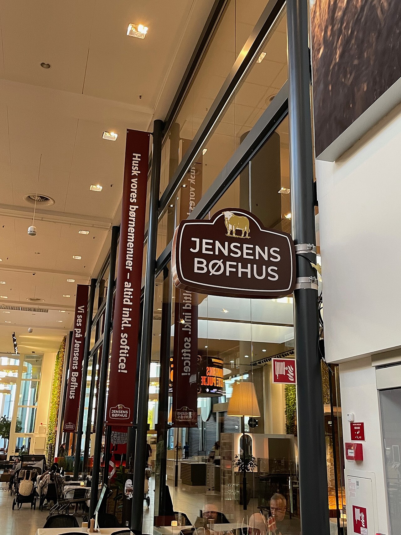 Jensens Bøfhus restaurant in Kolding Storcenter, Kolding, Denmark, showing the restaurant entrance and signage inside the shopping centre.
