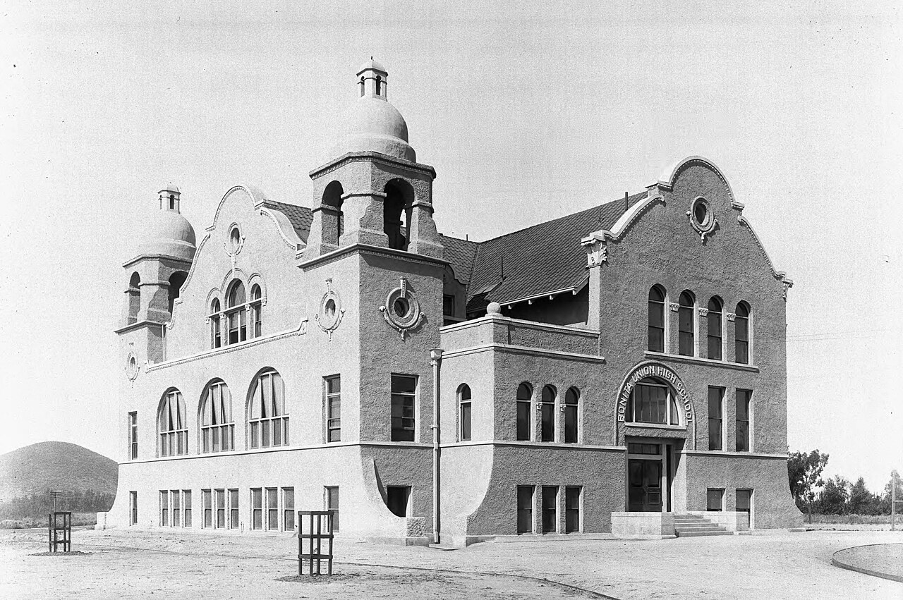 Exterior view of the Bonita Union high School serving two cities, (Lordsburg) San Dimas and La Verne, ca.1900
Photograph of the exterior view of the Bonita Union high School serving two cities, (Lordsburg) San Dimas and La Verne, California, ca.1900. The three-story, mission-style building features multicurved gables, ornamental traceries and moldings around windows and parapets, arched windows and Spanish tiled roofs. The building has two bell towers capped with dome roofs (one on each corner on the left side of the building). A driveway circles around the façade of the building and around the building. To the left of the driveway are two newly planted trees. A hill is visible behind the building (at left).; "Bonita was organized as a result of a 1902 State Constitutional Amendment which set aside state money for high schools. The high school students met first in a vacant store building, then in the La Verne Heights School building. Since Bonita served both La Verne and San Dimas, the site chosen on Bonita and (what was then) Grand Avenue, was midway between the two towns. The first (and only building until 1920) was completed for the 1904 fall session, and opened with 2 teachers and 34 students. The first graduating class in 1907 contained only 1 graduate. In 1910 there were only 70 students and five teachers, including the principal. By 1920 there were 120 students, and by 1930 there were 350 students and 21 teachers." -- unknown author.
Call number: CHS-5283
Filename: CHS-5283
Coverage date: circa 1900
Part of collection: California Historical Society Collection, 1860-1960
Format: glass plate negatives
Type: images
Geographic subject (city or populated place): San Dimas
Repository name: USC Libraries Special Collections
Accession number: 5283
Microfiche number: 1-18-46
Archival file: chs_Volume53/CHS-5283.tiff
Part of subcollection: Title Insurance and Trust, and C.C. Pierce Photography Collection, 1860-1960
Repository address: Doheny Memorial Library, Los Angeles, CA 90089-0189
Geographic subject (country): USA
Format (aacr2): 2 photographs : glass photonegative, photoprint, b&amp;w ; 21 x 26 cm., 20 x 25 cm.
Rights: Digitally reproduced by the USC Digital Library; From the California Historical Society Collection at the University of Southern California
Subject (adlf): educational facilities
Project: USC
Repository email: specol@usc.edu
Contributing entity: California Historical Society
Date created: circa 1900
Publisher (of the digital version): University of Southern California. Libraries
Format (aat): photographic prints; photographs
Geographic subject (state): California
Subject (file heading): Los Angeles County -- San Dimas
Legacy record ID: chs-m6522; USC-1-1-1-6637
Access conditions: Send requests to address or e-mail given. Phone (213) 821-2366; fax (213) 740-2343.
Geographic subject (county): Los Angeles
Subject (lcsh): High schools
Subject: Bonita Union High School