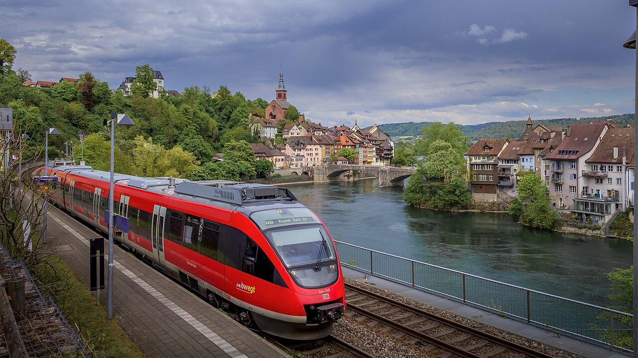 Regional train with BR 644 549 at Laufenburg (Baden) station. Heading towards Basel Badischer Bahnhof. In the background is the High Rhine and the old towns of Laufenburg.