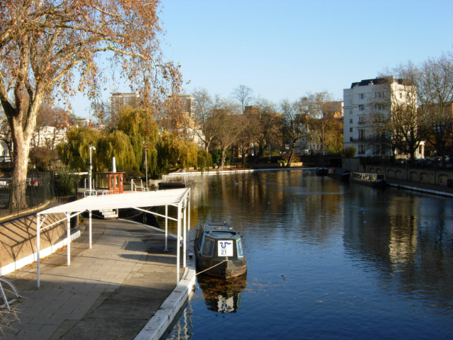 Little Venice Seen from Westbourne Terrace Road Bridge, Little Venice is the name given to the basin at the junction of the Regent's Canal and the Paddington Arm of the Grand Junction Canal - all part of the Grand Union Canal system.