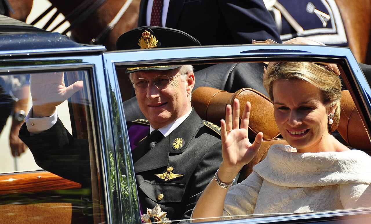 Belgian King Philippe and Queen Mathilde wave to the crowds in Brussels after Philippe's swearing in as new Belgian king.