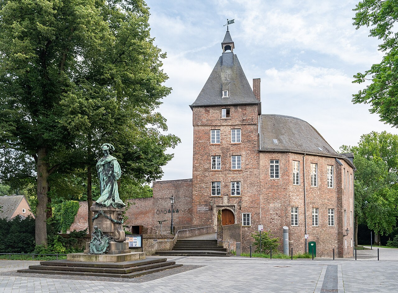 Moers Castle and statue of Countess Louise Henriette of Nassau in Moers in the evening, North Rhine-Westphalia, Germany.