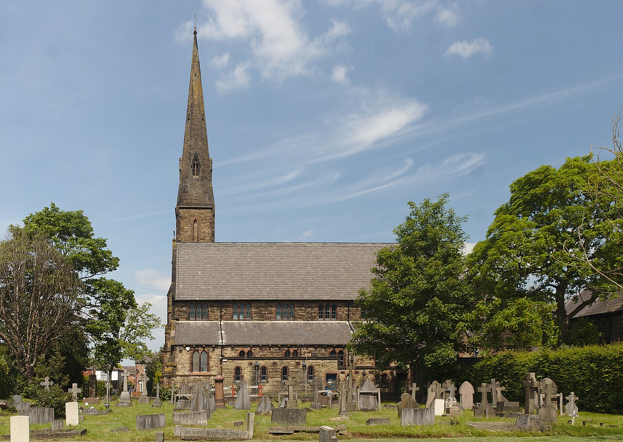 The south side of Grade II listed Ss Mary & John church, Newton-le-Willows across the churchyard.
