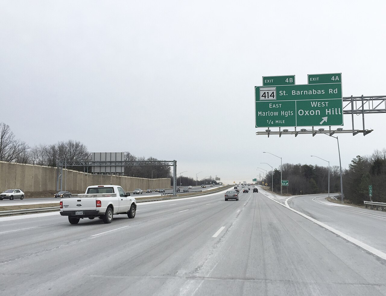 View north along the outer loop of the Capital Beltway (Interstate 95 and Interstate 495) at Exit 4A (Maryland State Route 414 West/St. Barnabas Road, Oxon Hill) along the edge of Glassmanor and Oxon Hill in Prince Georges County, Maryland