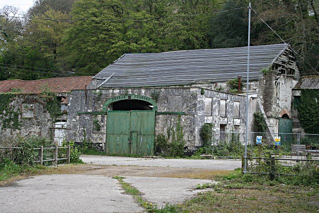 The Perran Foundry. This derelict industrial site awaiting "sympathetic redevelopment" is of international significance.  Above the green door, the name plate shows the year 1791 as the date of establishment of the foundry.  The foundry was most active from the 1820's to the 1860's when it made and shipped huge mine pumping engines all over the world.  Engines created here were sent to mines in South Australia, Mexico and South Africa.  Along with each engine, the company would normally send an engineer to assemble, install and run the engine.