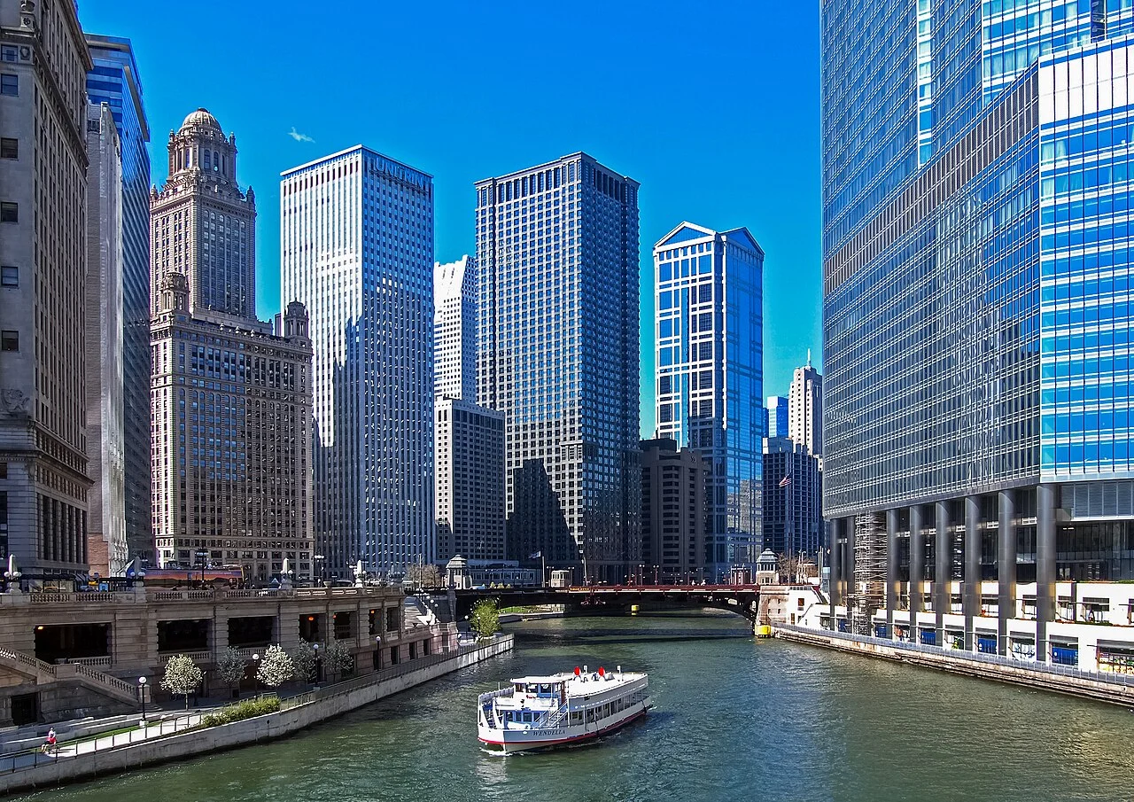 A Chicago River tour boat passes in front of Trump Tower