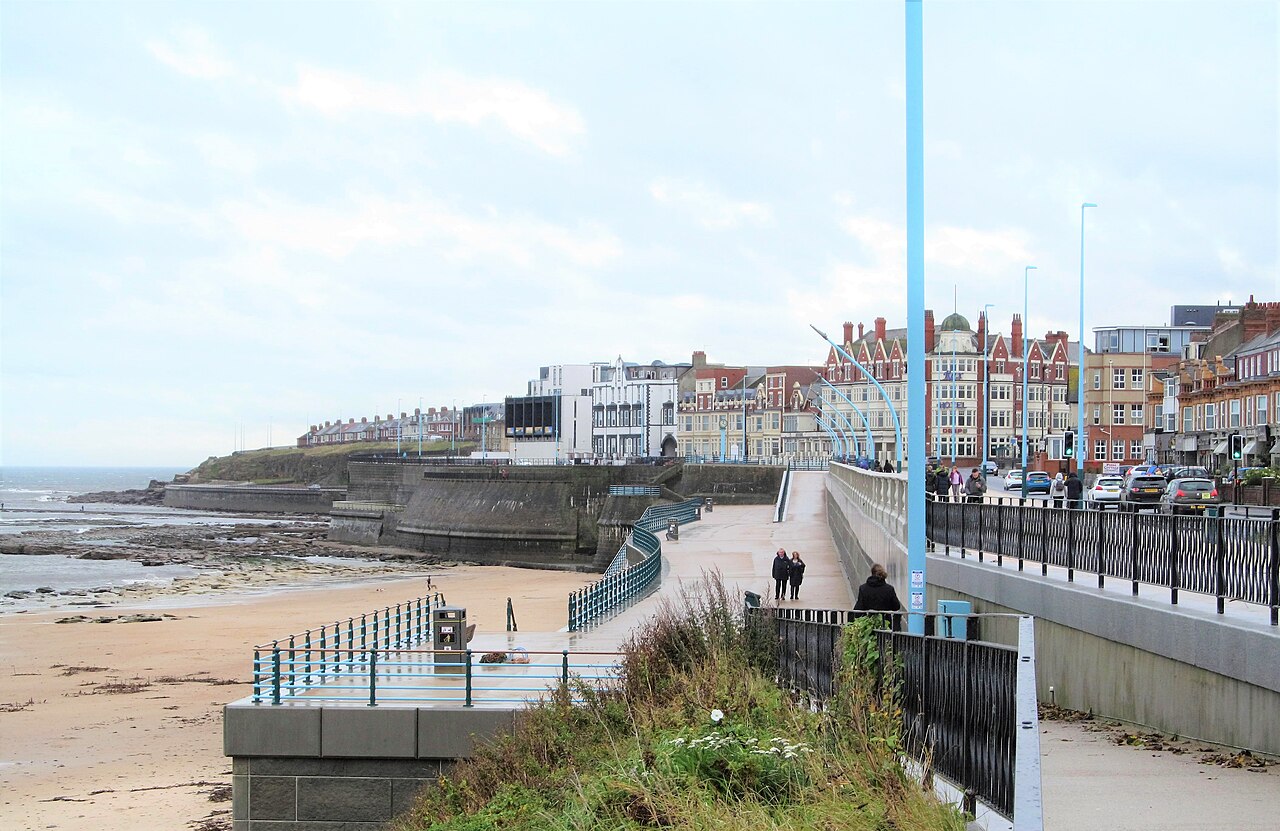A few people braving the elements on an October day of high temperatures but also rain.