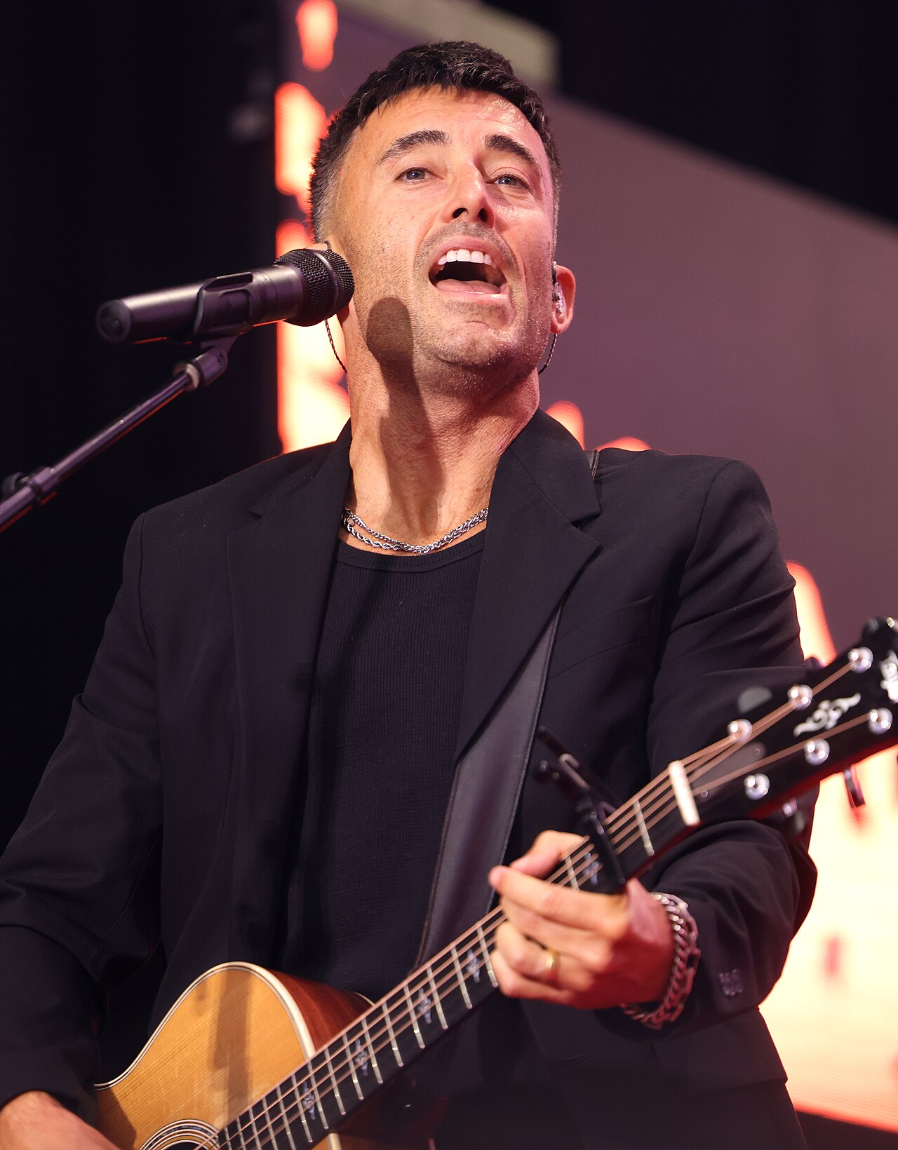 Phil Wickham performing for attendees at the Memorial for Charlie Kirk at State Farm Stadium in Glendale, Arizona