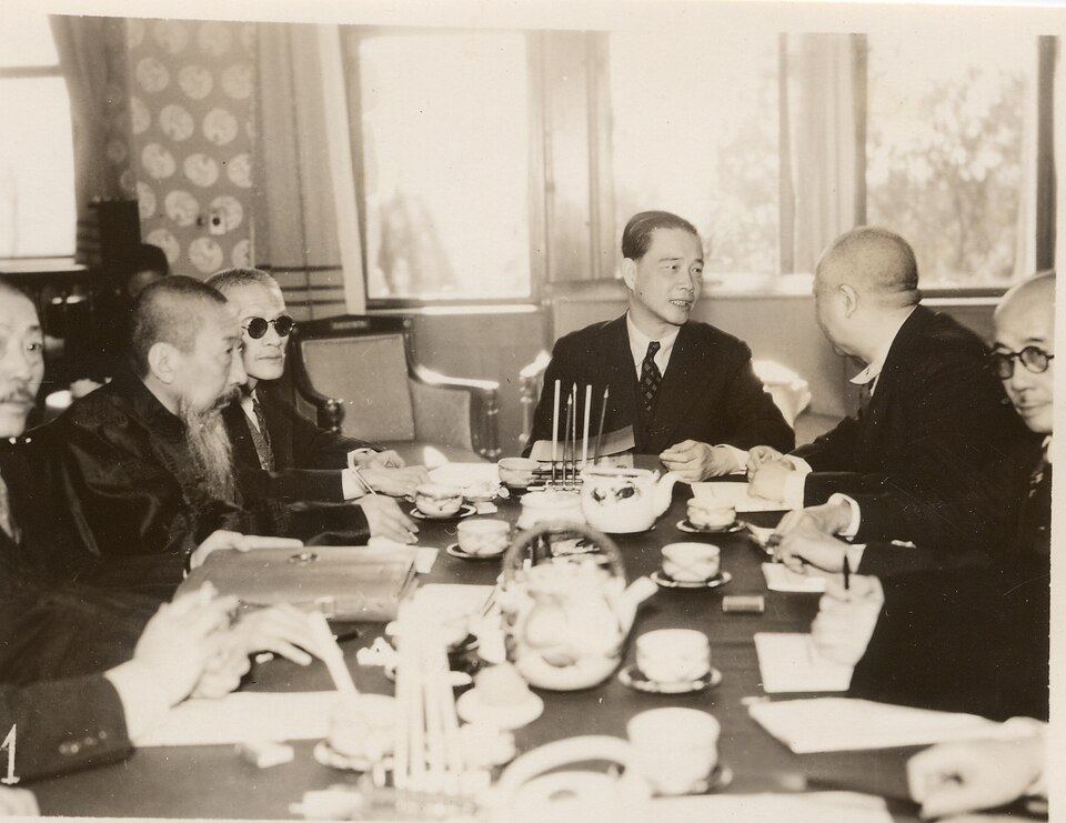 Caption on reverse [translation]: "2nd Day of the Qingdao Conference. (Qingdao 26th). 1. The conference continued with Wang taking the lead. Photograph: (from right) Wen, Liang, Wang, Wang, Wang Kemin (taken at the reception hall on the 25th). [Stamped] January 26, 1940."