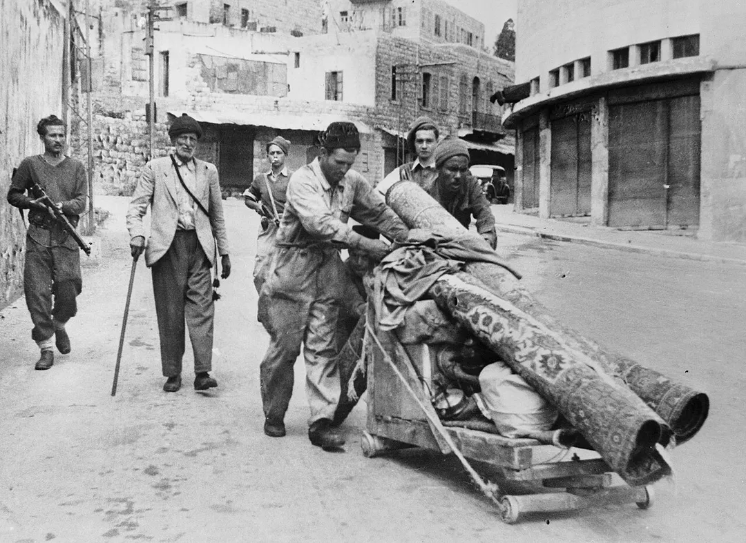 "Arab residents being forced out of Haifa, by the armed Haganah men, April, 1948." per Haaretz