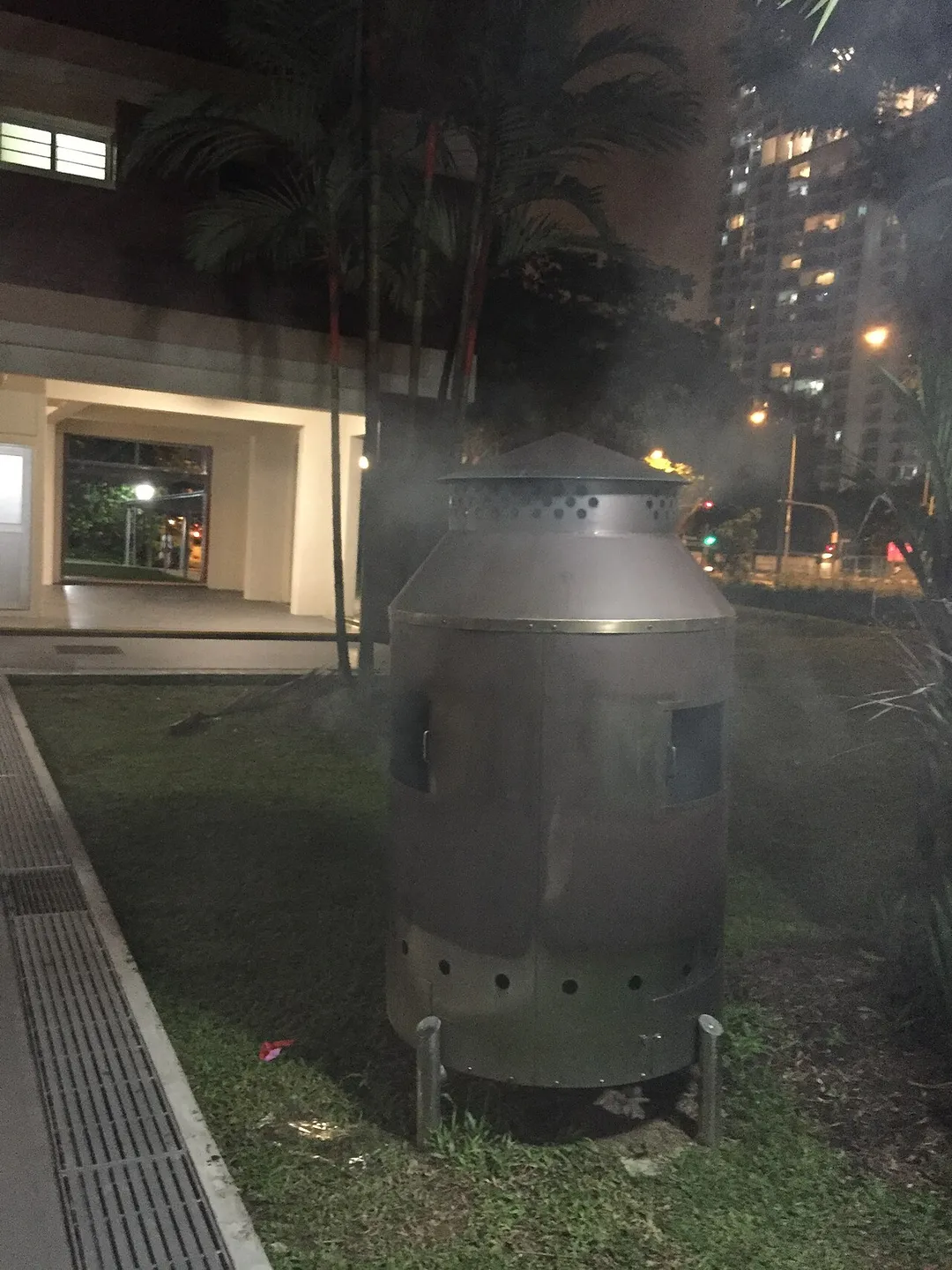 A incense burner emitting smoke at Clarence Ville, a Housing and Development Board (HDB) estate off Alexandra Road, Singapore. Such burners are used by members of the Chinese community to burn paper offerings.