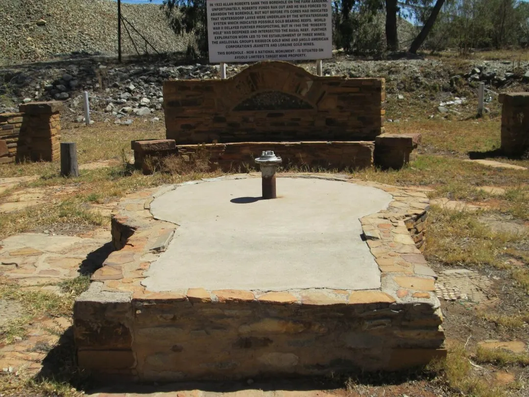Prospecting bore-hole, Aandenk, Allanridge. It was at this site where Allan Roberts proved the deposits (basal reef and carbon leader reef) of gold in the Orange Free State and triggering the rush which unintentionally justified the implementation of Apartheid in South Africa. Prospecting started in 1932 but the area was proven beyond doubt in 1946 with the Geduld strike.