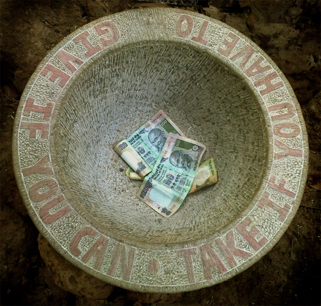 A stone sculpture created by an American Conceptual and Land artist Jacek Tylicki. Name of artwork: "Give if you can - Take if you have to". Location: Lake Beach Valley, Arambol, Goa, India.