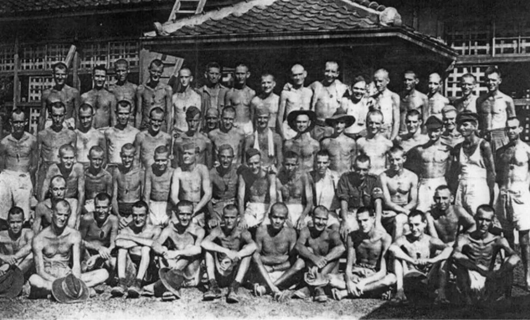 Australian prisoners of war forced to work for the Aso mining company in Kyushu, Japan pose for a group picture in August 1945.