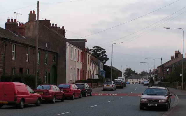Aspatria, west approach. The A596(T) passes through the centre of Aspatria. These terraces are typical of the older housing in the town, which is the home of Sealy Beds.