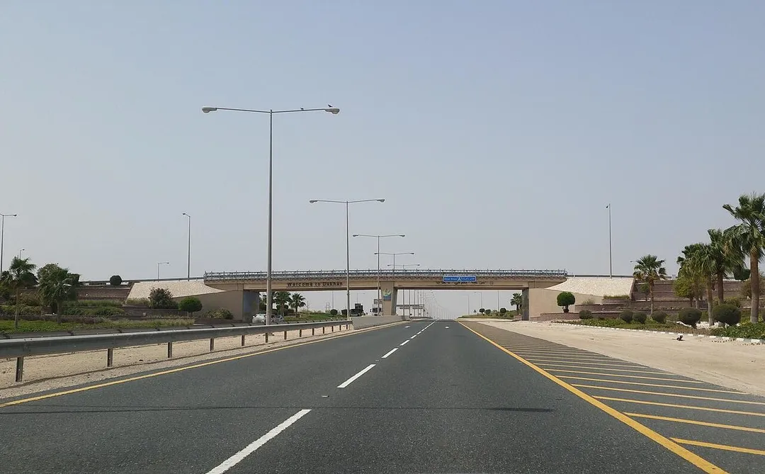 Welcome to Dukhan sign on Zekreet Bridge as seen from Dukhan Highway in western Qatar.