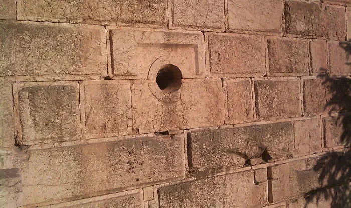 Exterior of Baalbek temple. Shaft of unknown function leading to the interior of what is now the museum. Taken and released into the public domain by Paul Bedson.