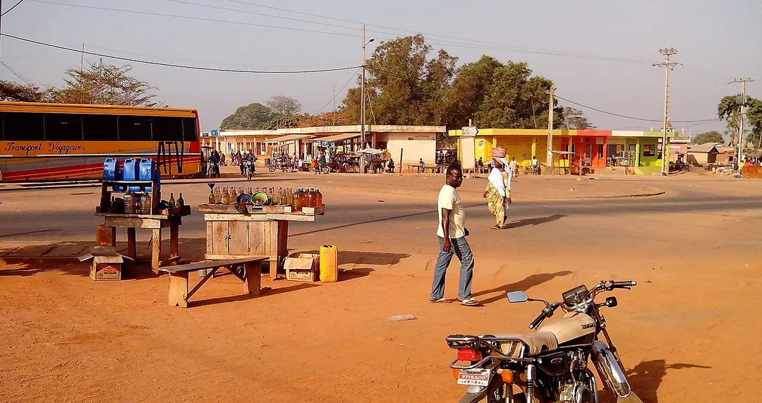 the town center of Bassila, looking accross the roundabout towards the new market-units; note the electrical infrastructure and the paved main road