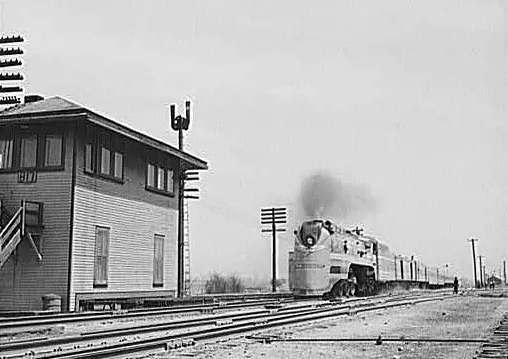 Milwaukee Road class F7 locomotive (type 4-6-4) hauling the "Midwest Hiawatha" past Tower B17, Bensenville, Illinois.Original caption was: "Bensenville, Illinois. The "Midwest Hiawatha" of the Chicago, Milwaukee, Saint Paul and Pacific Railroad speeding through Bensenville, Illinois"