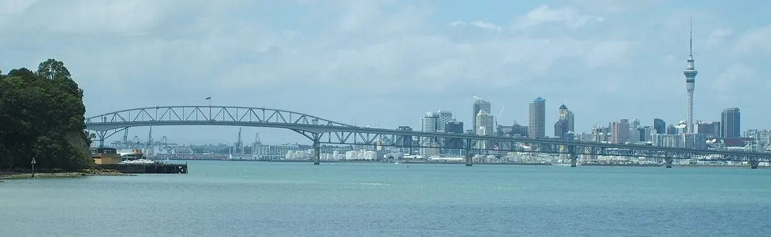 Auckland Harbour Bridge from Chelsea Sugar Refinery, showing Birkenhead Wharf in the foreground and the CBD in the background. Auckland, New Zealand.