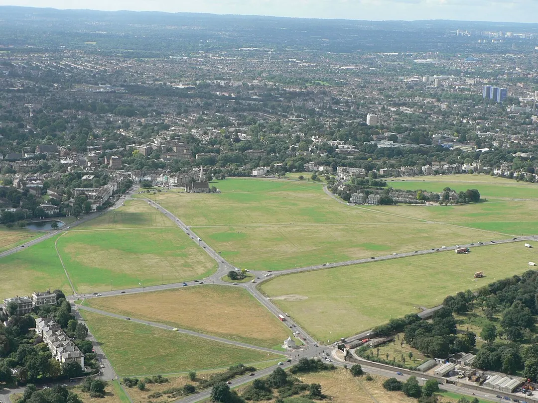 An aerial view of the Heath at Blackheath, London. A minor ridge after a short dip reaching a peak at Shooter's Hill in the east; here the towers of central Lewisham and Croydon are beyond to the south-west (right). The backdrop is the long crest of the North Downs in the far south of Bromley and adjoining Surrey