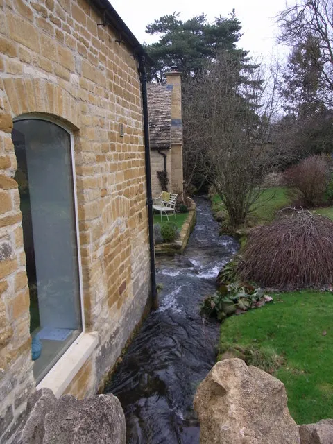 The Dove, Blockley. Stream flowing behind houses,through gardens.