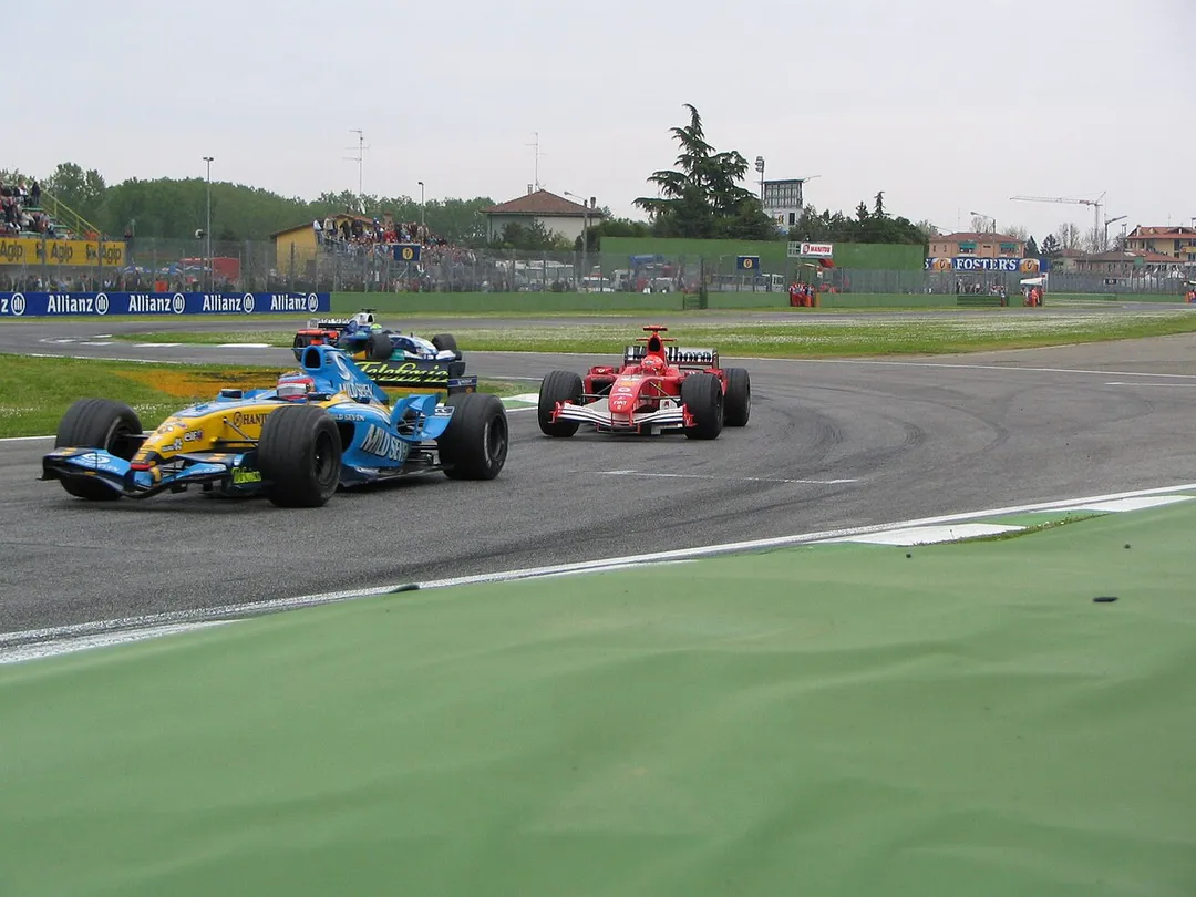 Fernando Alonso and Michael Schumacher battle for the lead of the 2005 San Marino Grand Prix. Felipe Massa's Sauber is also pictured behind Alonso and Schumacher.