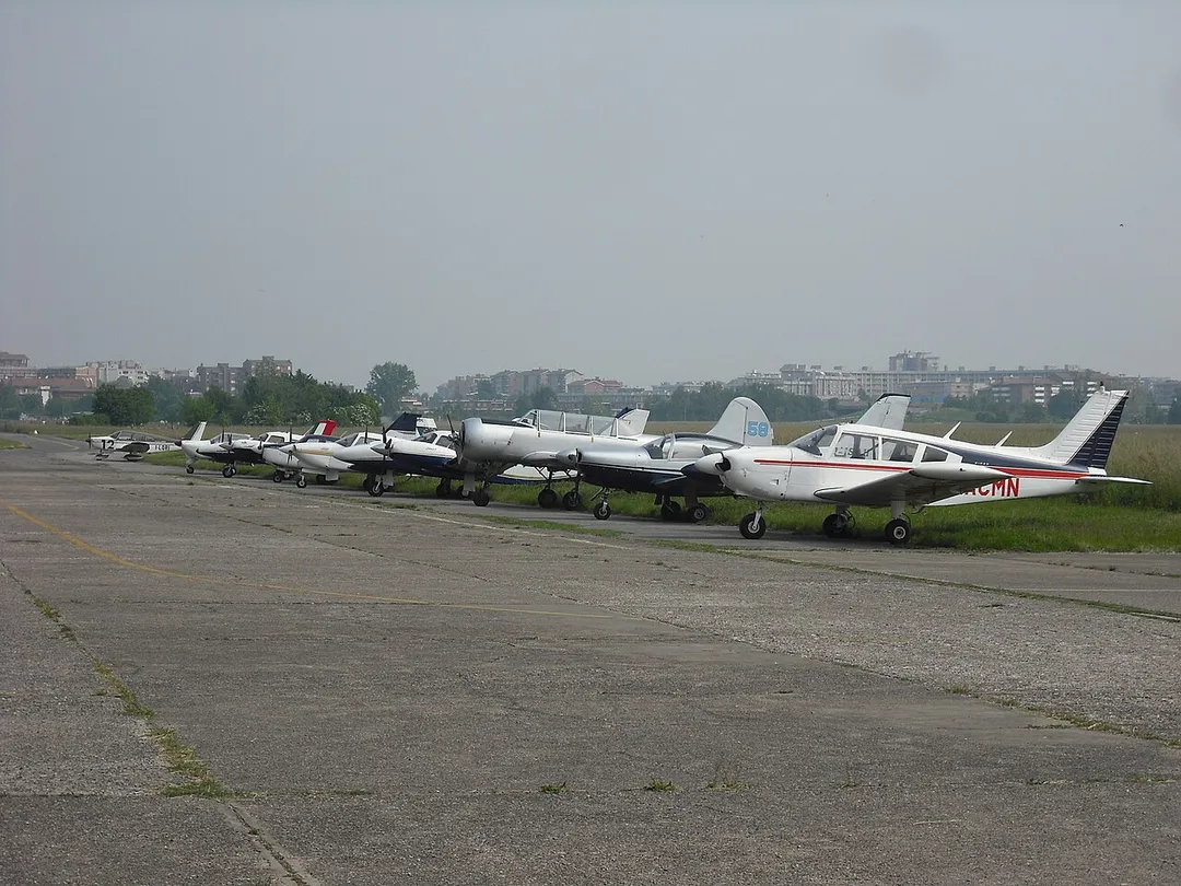 General aviation aircraft lined up in front of the hangars of Milano-Bresso airport, Milan, Italy.