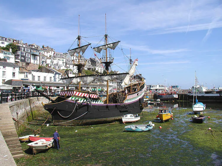 A replica of Sir Francis Drake's ship - the Golden Hind - lying permanently in Brixham Harbour. The original ship, with a crew of 80 sailors and 10 officers, circumnavigated the globe between 1577 and 1580. Five ships set out -  Pelican, Elizabeth, Swan, Marigold and Benedict. During the voyage the Pelican was renamed the Golden Hind in honour of his friend Christopher Hatton whose  crest featured a hind (a deer). Sir Francis brought home looted gold, silver, jewels and cash worth 25 million pounds in today's (2003) money. Only two of the ships returned, the Golden Hind and the Elizabeth. Taken by Adrian Pingstone in July 2003 and released to the public domain.