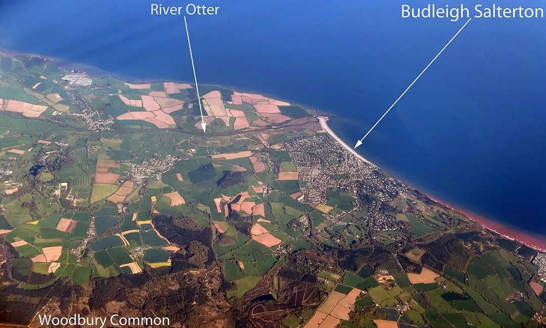 An aerial photo of Budleigh Salterton and the surrounding area. Also labelled are the river Otter and Woodbury Common.
