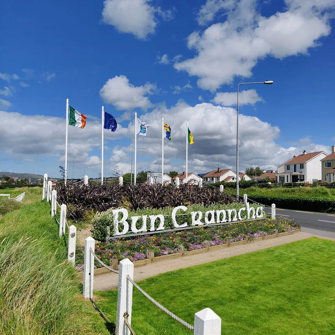 Bun Cranncha displaying various flags, as seen when entering via Railway Road R238