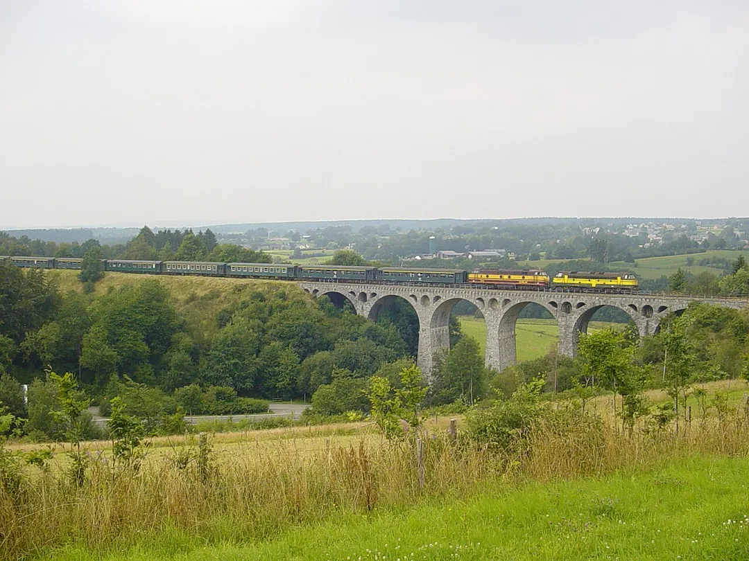 Bridge of Vennquerbahn railroad outside Bütgenbach, Wallonia, Belgium, in the area ceded to Belgium by Germany after World War I. It is 104 m long and 30 m high. This line was opened in 1912 [1] and operated for passenger trains until 1952 and for freight trains until 2003. The train in the picture was organized for a railfan tour by PFT-TSP association.

The locomotives depicted are SNCB/NMBS 5307 &amp; CFL 1805.