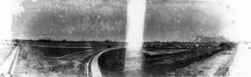 A view of Carroll Park before it was subdivided by John Carroll and homes built between 1898 and 1923. The subdivision was incorporated into Long Beach. This photograph shows rural roads running past fields and trees in a flat landscape.